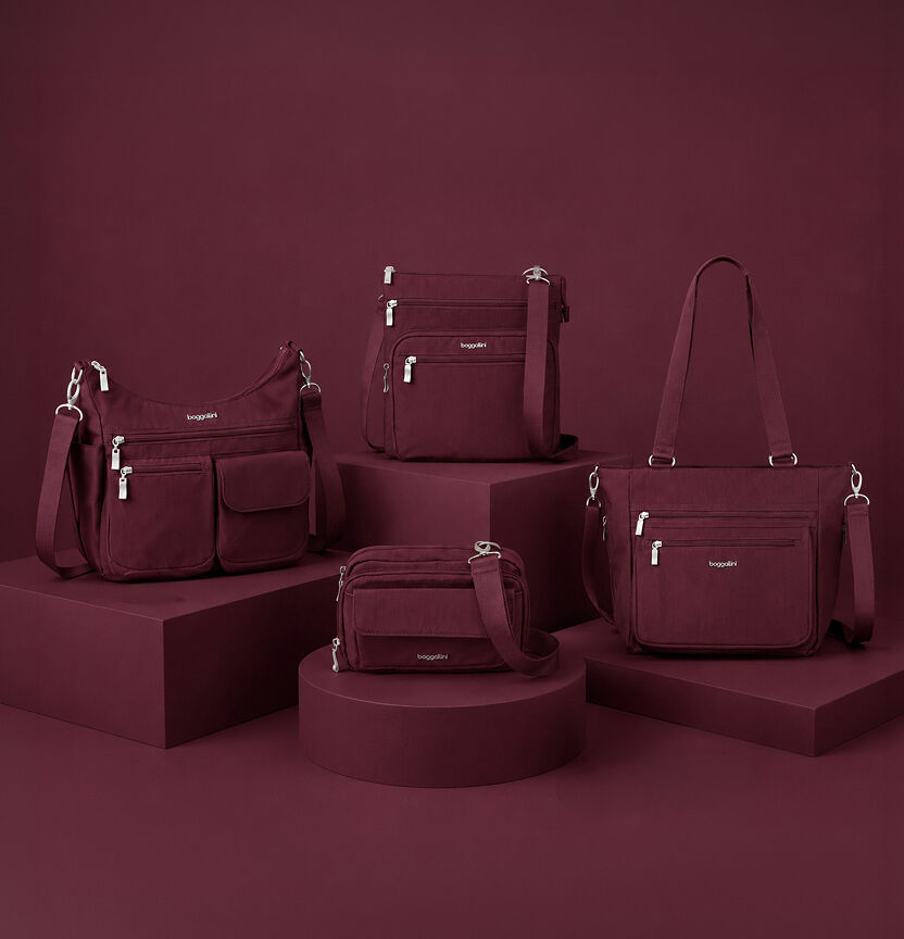 Baggallini handbags in rich burgundy displayed together, including crossbody bags, shoulder bags, and a tote from the Fall collection.